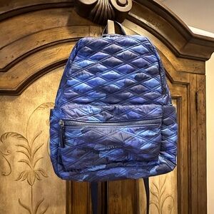 Baggallini Blue Quilted Backpack with laptop sleeve and luggage sleeve.